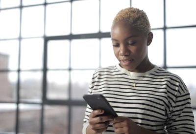 Woman looking at phone smiling